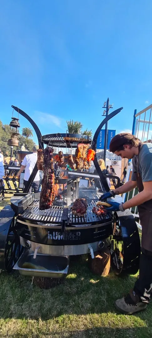 A man barbecuing on a large firebox