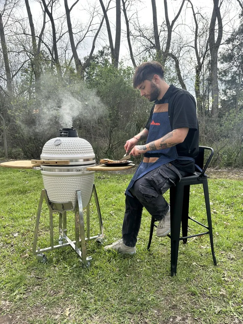 A man cooking in a WHITE CERAMIC OVEN 18
