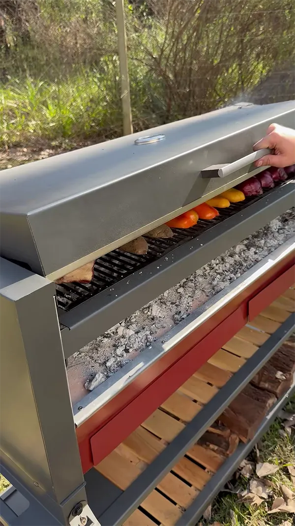 Covered federal grill with embers and meat in it